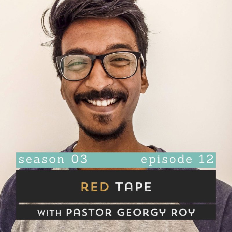 The Pantry Podcast - S03E11 - Red Tape with Pastor Georgy Roy - Georgy smiling into the camera.