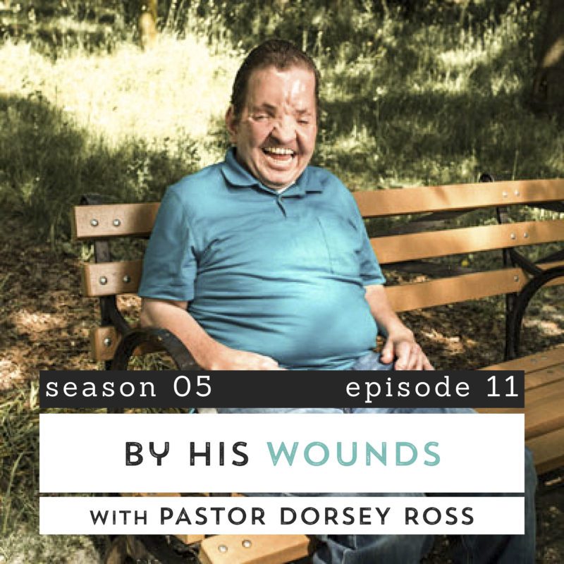 Pastor Dorsey Ross smiling, sitting on a park bench