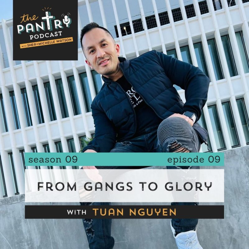 Tuan Nguyen sitting on concrete wall in front of industrial office building.