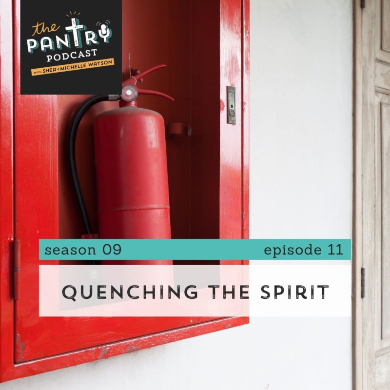 What does it mean to quench the spirit? Fire extinguisher hanging in red storage unit on wall in white hallway.